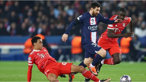 Lionel Messi of Paris Saint-Germain is challenged by Jamal Musiala and is marked by Dayot Upamecano of FC Bayern Munich
