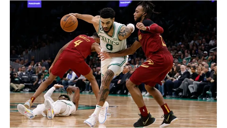 Jayson Tatum #0 of the Boston Celtics drives on Darius Garland #10 of the Cleveland Cavaliers