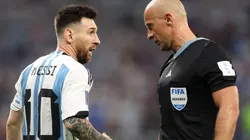 Lionel Messi of Argentina and referee Szymon Marciniak