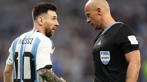 Lionel Messi of Argentina and referee Szymon Marciniak