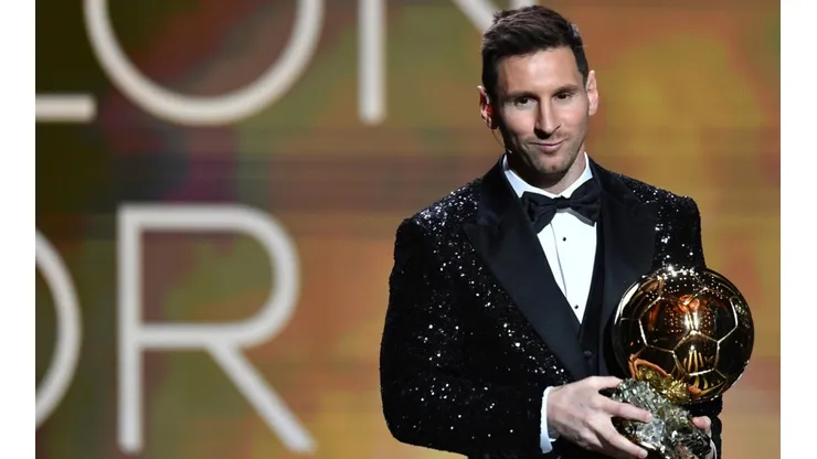 Lionel Messi with the Ballon d'Or award.