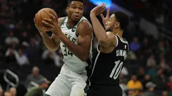 Giannis Antetokounmpo #34 of the Milwaukee Bucks is defended by Ben Simmons #10 of the Brooklyn Nets