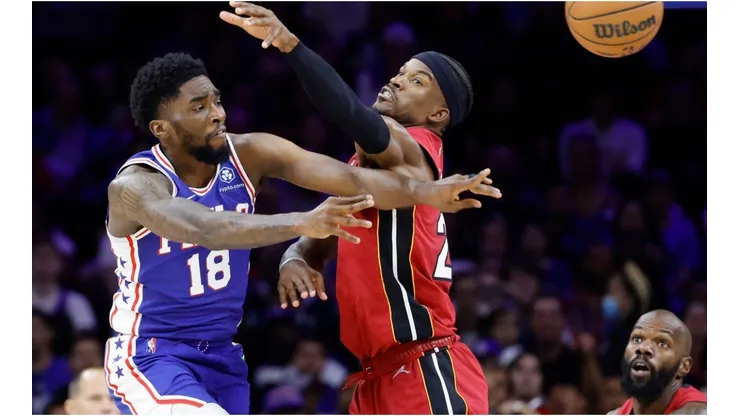 Shake Milton of the Philadelphia 76ers passes the ball against Jimmy Butler of the Miami Heat