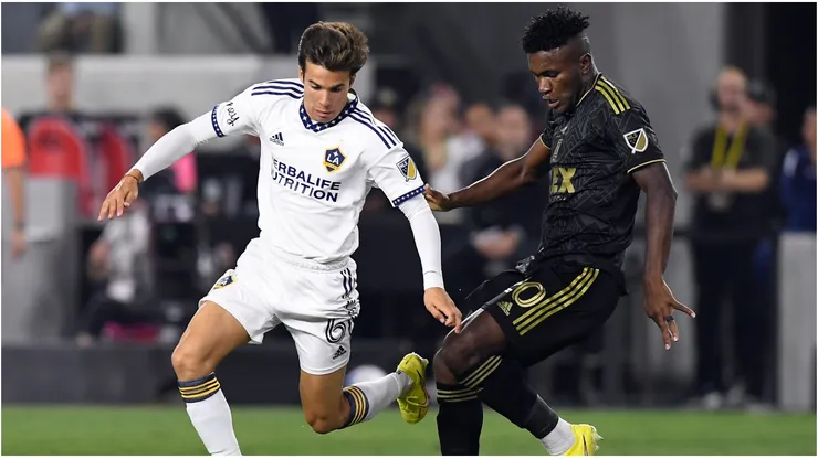 Riqui Puig #6 of Los Angeles Galaxy controls the ball against Jose Cifuentes #20 of Los Angeles FC