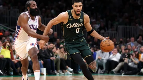 James Harden #1 of the Philadelphia 76ers defends Jayson Tatum #0 of the Boston Celtics