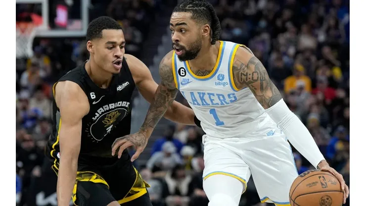 Jordan Poole of the Golden State Warriors and D'Angelo Russell of the Los Angeles Lakers