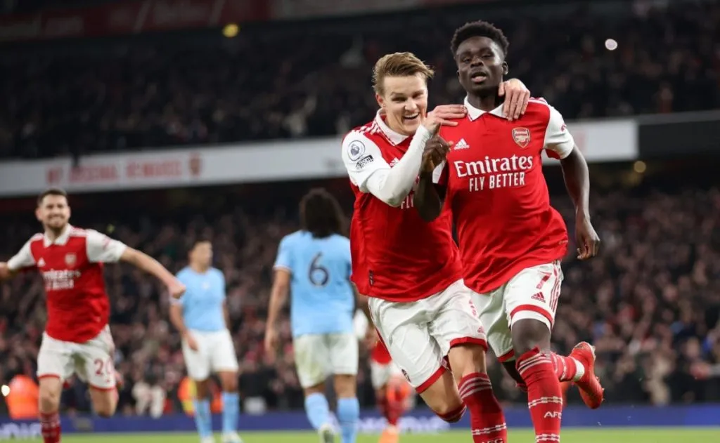 Bukayo Saka of Arsenal celebrates with teammate Martin Odegaard