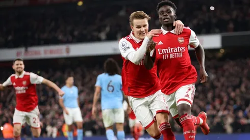 Bukayo Saka of Arsenal celebrates with teammate Martin Odegaard