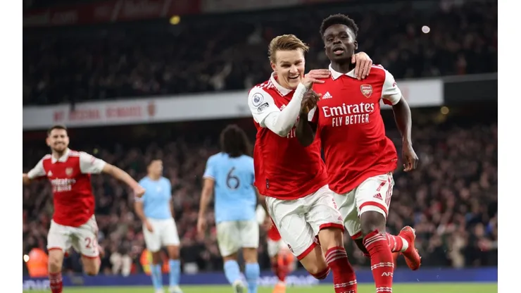 Bukayo Saka of Arsenal celebrates with teammate Martin Odegaard