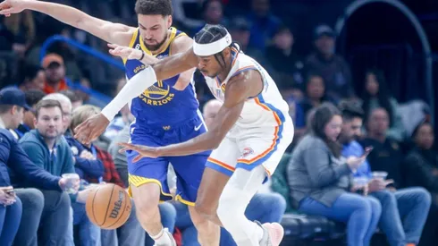 Shai Gilgeous-Alexander #2 of the Oklahoma City Thunder steals the ball from Klay Thompson #11 of the Golden State Warriors
