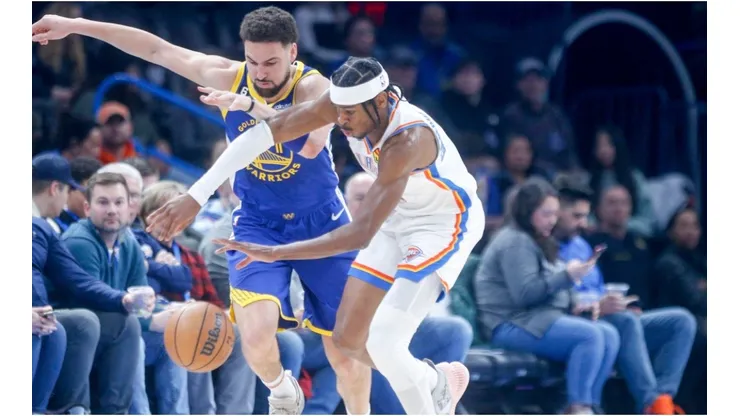 Shai Gilgeous-Alexander #2 of the Oklahoma City Thunder steals the ball from Klay Thompson #11 of the Golden State Warriors