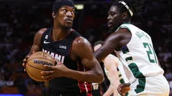 Jimmy Butler #22 of the Miami Heat drives against Jrue Holiday #21 of the Milwaukee Bucks