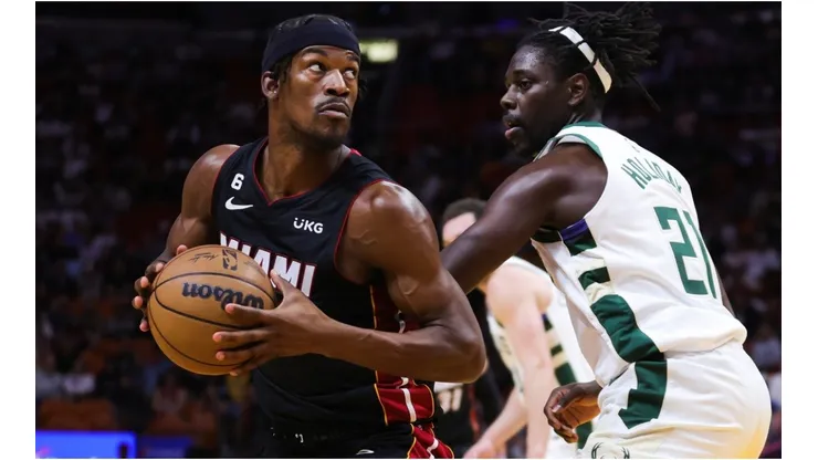 Jimmy Butler #22 of the Miami Heat drives against Jrue Holiday #21 of the Milwaukee Bucks