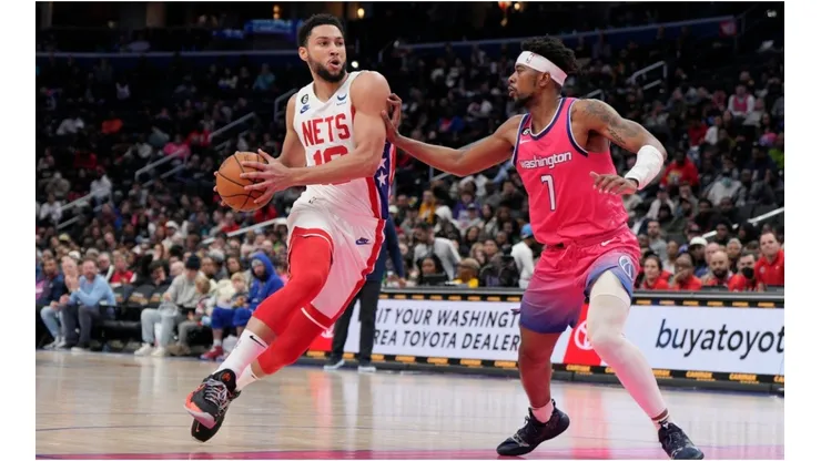 Ben Simmons #10 of the Brooklyn Nets drives to the hoop as Jordan Goodwin #7 of the Washington Wizards