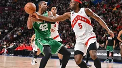 Al Horford of the Boston Celtics protects the ball from Precious Achiuwa of the Toronto Raptors
