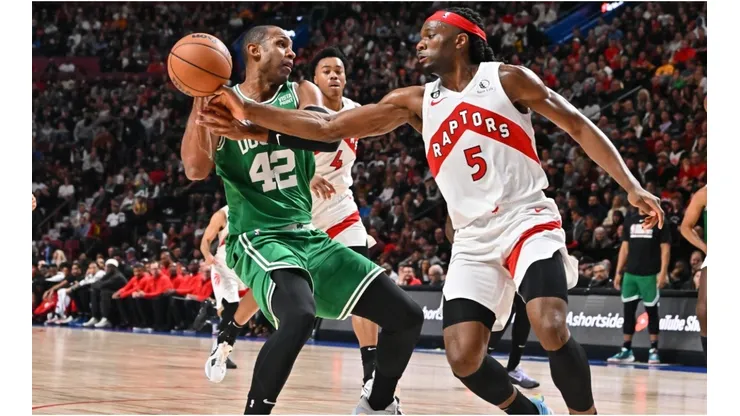 Al Horford of the Boston Celtics protects the ball from Precious Achiuwa of the Toronto Raptors