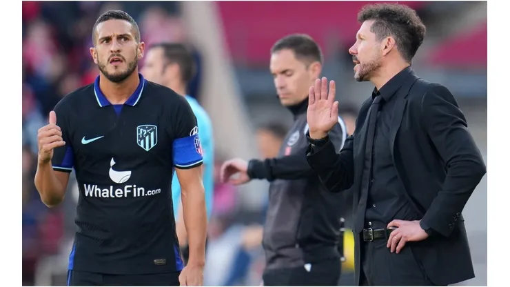 Diego Simeone, Head Coach of Atletico Madrid, gives Koke instructions