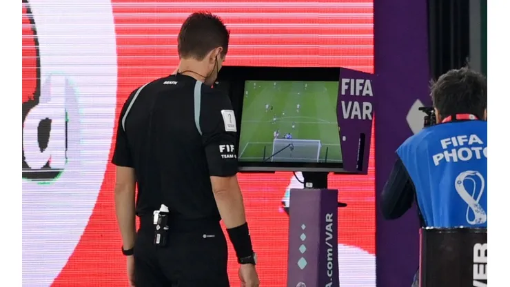 Referee making a VAR review at Qatar 2022.