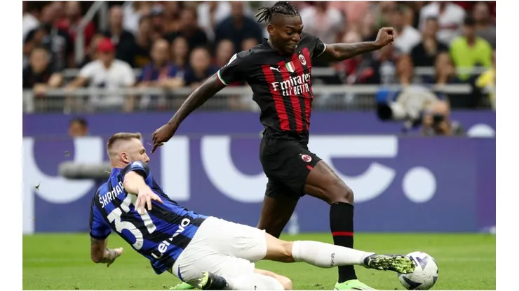 Milan Skriniar of FC Internazionale challenges Rafael Leao of AC Milan