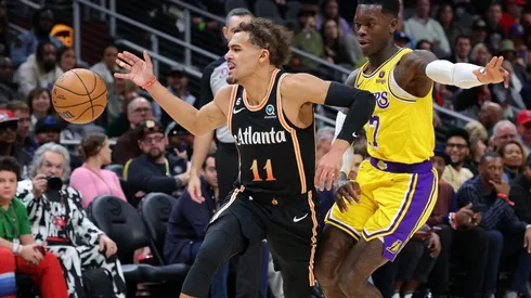 Trae Young of the Atlanta Hawks loses the ball as he drives against Dennis Schroder of the Los Angeles Lakers