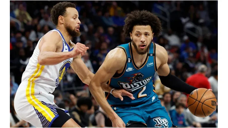 Cade Cunningham of the Detroit Pistons dribbles on Stephen Curry of the Golden State Warriors