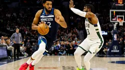 Karl-Anthony Towns of the Minnesota Timberwolves drives to the basket while Wesley Matthews of the Milwaukee Bucks