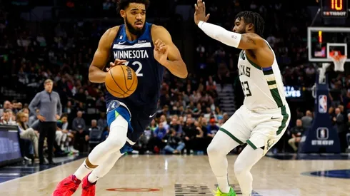 Karl-Anthony Towns of the Minnesota Timberwolves drives to the basket while Wesley Matthews of the Milwaukee Bucks