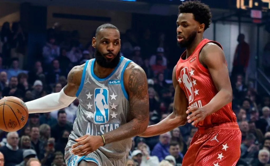 LeBron James of Team LeBron dribbles the ball around Andrew Wiggins of Team Durant.