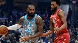 LeBron James of Team LeBron dribbles the ball around Andrew Wiggins of Team Durant