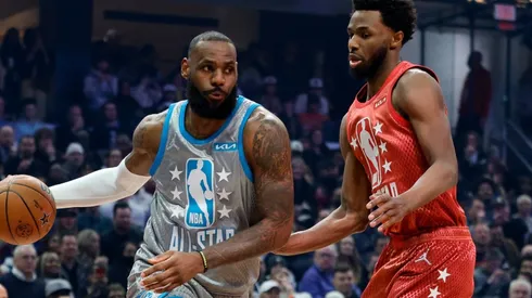 LeBron James of Team LeBron dribbles the ball around Andrew Wiggins of Team Durant