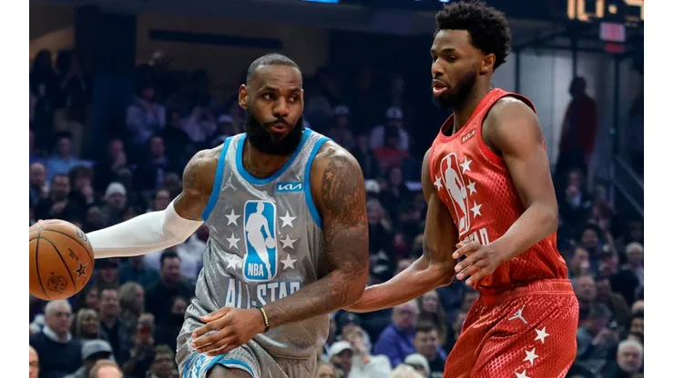 LeBron James of Team LeBron dribbles the ball around Andrew Wiggins of Team Durant