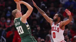 AJ Green of the Milwaukee Bucks shoots over Coby White of the Chicago Bulls