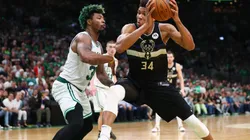 Giannis Antetokounmpo of the Milwaukee Bucks drives to the basket against Marcus Smart of the Boston Celtics
