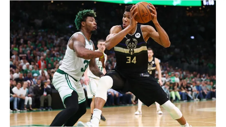 Giannis Antetokounmpo of the Milwaukee Bucks drives to the basket against Marcus Smart of the Boston Celtics