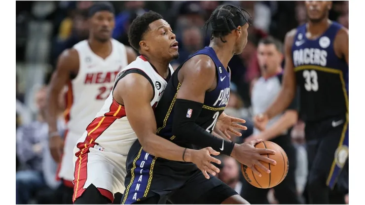 Kyle Lowry of the Miami Heat defends Buddy Hield of the Indiana Pacers