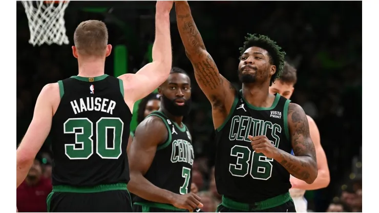 Marcus Smart of the Boston Celtics high-fives Sam Hauser