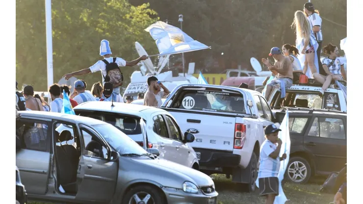 Fans of Argentina wave flags outside Argentina's training facilities