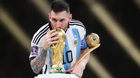 Lionel Messi with the World Cup trophy and the Golden Ball