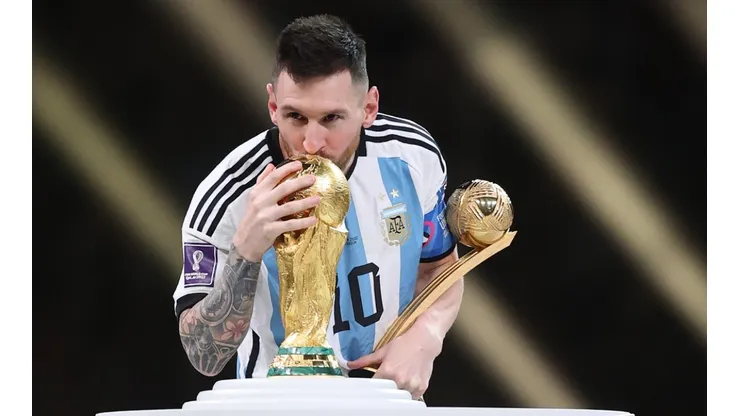 Lionel Messi with the World Cup trophy and the Golden Ball