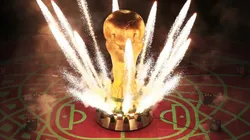 Pyrotechnics explode around a giant World Cup trophy