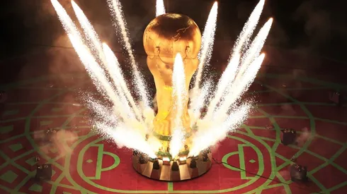 Pyrotechnics explode around a giant World Cup trophy
