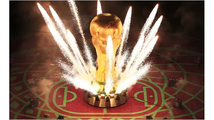 Pyrotechnics explode around a giant World Cup trophy
