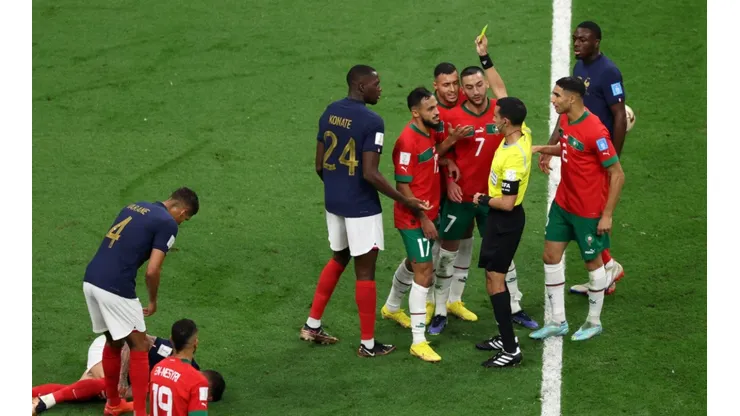 Sofiane Boufal of Morocco is shown a yellow card by Referee Cesar Arturo Ramos