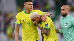 Neymar of Brazil reacts with Thiago Silva (L) and Dani Alves after the loss via a penalty shootout