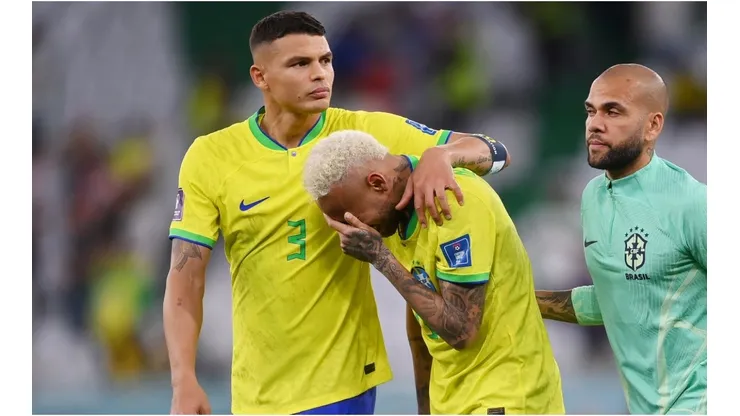 Neymar of Brazil reacts with Thiago Silva (L) and Dani Alves after the loss via a penalty shootout