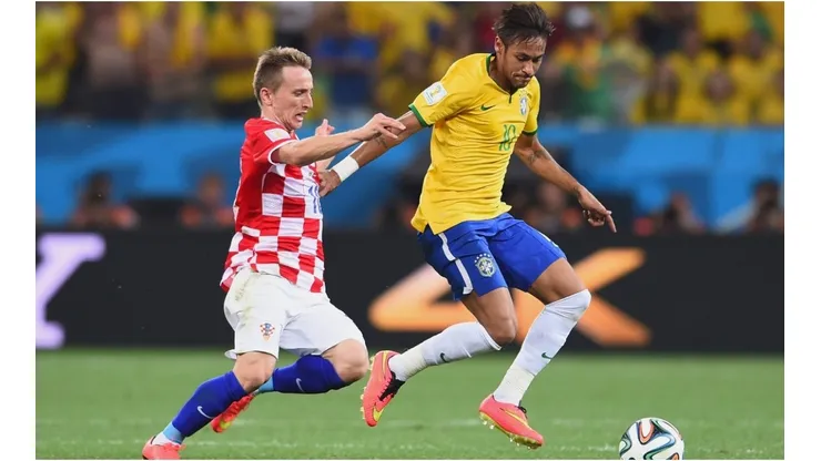 Luka Modric of Croatia tackles Neymar of Brazil during the 2014 FIFA World Cup