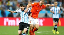 Lionel Messi of Argentina is challenged by Ron Vlaar of the Netherlands during the 2014 FIFA World Cup Brazil Semi Final
