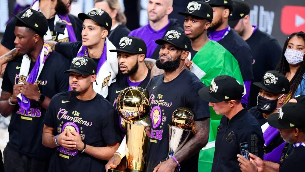 LeBron James #23 of the Los Angeles Lakers reacts with his MVP trophy and Finals trophy after winning the 2020 NBA Championship over the Miami Heat. Douglas P. DeFelice/Getty Images