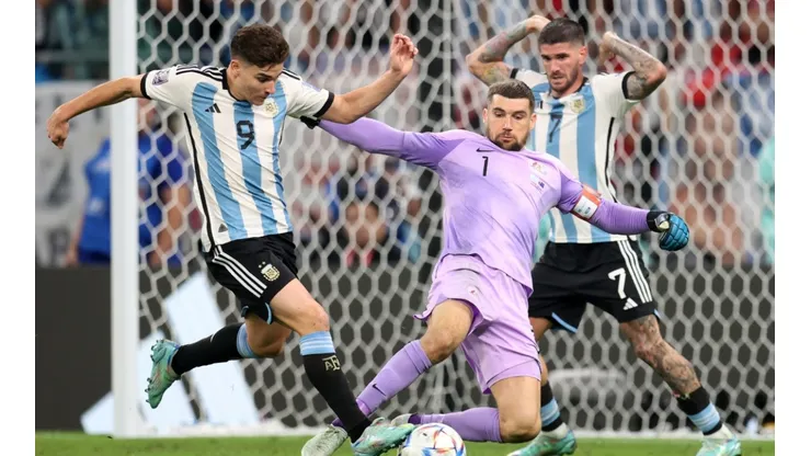 Julian Alvarez of Argentina scores the team's second goal past Mathew Ryan of Australia
