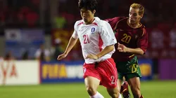 Ji Sung Park of South Korea holds off Petit of Portugal